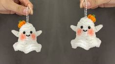 two handmade christmas ornaments are being held by someone's hands, one is wearing an orange and white headband