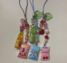 several charms are hanging on a white surface