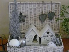 a wicker basket filled with christmas decorations