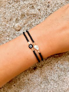 These evil eye bracelets are handmade-to-order just for you! 🧿 Evil eye jewelry dates as far back as 3000 BC. Many ancient cultures wore amulets or jewelry with the evil eye symbol to protect them. Today the evil eye brings good luck and good vibes. An evil eye in black also represents strength, power, and prosperity! Each one is made-to-order and features a handmade lampwork evil eye bead. Because the beads are handmade each one is unique and there may be slight variations in the size and shape.  From the drop-down menu you can choose between the evil eye bracelet, the shell bracelet, or both/set of two (as seen in photo #1).  The shell bracelet features genuine sea shells from Bali. Each shell is unique and hand chosen for its natural beauty.  🧿 Materials: Handmade Lampwork Evil Eye Be Evil Eye Bracelet Diy, Black Evil Eye Bracelet, Pulseras Ideas, Black Evil Eye, Beaded Evil Eye, Bead Animals, Beachy Necklace, Bff Drawings, Greek Evil Eye