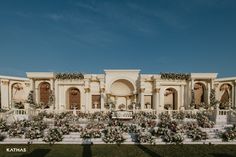 an elaborately decorated building with flowers and greenery