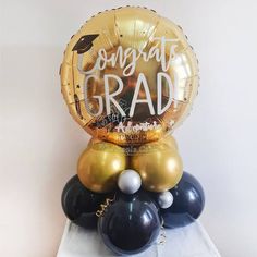 congratulations grad balloon on top of balloons