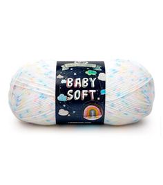 a ball of baby soft yarn in white and blue with multicolored stars on it