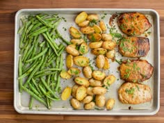 the meal is prepared and ready to be eaten on the table, including potatoes, green beans, and pork chops