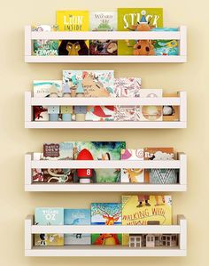 three white bookshelves filled with children's books on top of each other