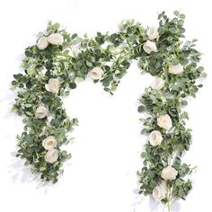 white roses and greenery are arranged in the shape of an o - shaped letter