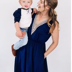 WOMEN'S- Mom's knee length dress is made with silky soft navy blue cotton like fabric with a small percent of spandex making them stretchy and comfortable. Convenient side pockets, a stretchy elastic waist for an easy pullover fit, and an elegant off-white lace accent adorns the bust of each dress. . SON- Dress your sweet boy in a smart 3/4 length sleeved shirt. The navy and light beige color creates the perfect matching piece to go with the women's dress for a mommy and son set you will love getting complimented on. Perfectly coordinated outfits for your next family photoshoot! Stretch Dresses With Side Pockets For Spring, Spring Stretch Dresses With Side Pockets, Spring Dresses With Side Pockets And Stretch, Fitted Blue Dresses With Side Pockets, Elegant Blue Dresses With Elastic Waistband, Blue Midi Dress With Elastic Waistband, Blue Cotton Dress With Side Pockets, Blue Cotton Dress With Elastic Waistband, Mommy Son