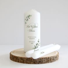 a bottle of lotion sitting on top of a wooden slice