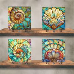 four stained glass panels on wooden shelves in different colors and sizes, each with an intricate shell design