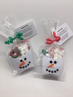 two bags filled with marshmallows in the shape of a snowman