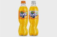 two bottles of fanta orange soda on a white background