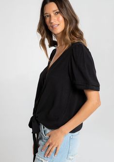 Designed in a fresh linen blend, our charming short sleeve top is a must-have style for Spring. With flirty short puff sleeves, an adjustable tie front waist, and a pretty self-covered button front. We love to style this effortless blouse with denim and a classic leather sandal. FINAL SALE Linen blend Relaxed fit Short puff sleeve Elastic cuff Tie front waist V-neckline Self-covered button front Pintuck details Lattice trim Classic bohemian top Model is 5'8, wearing a size S.Style: I-13804W-RJX Chic Short Sleeve Top For Spring Casual Gatherings, Chic Short Sleeve Top For Casual Gatherings In Spring, Casual Tops With Tie Puff Sleeves, Casual Tops With Tie And Puff Sleeves, Chic Short Sleeve Top For Casual Gatherings, Summer Solid Color Tops With Tie Waist, Casual Blouse With Puff Tie Sleeves, Casual V-neck Puff Sleeve Top For Daywear, Solid Color Summer Top With Tie Waist