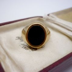 Vintage black onyx and 9k yellow gold signet ring.  In very good condition with light surface wear.  UK Size JP/Q - US Size 8 Hallmarked for 9k gold, Birmingham and stamped with maker's mark D&W. Weighs approx. 4 grams. Your ring will be sent gift wrapped - and boxes used in photos are for display purposes only and not included. Luxury Black Collectible Signet Ring, Luxury Black Victorian Style Signet Ring, Luxury Black Signet Ring Collectible, Luxury Black Art Deco Signet Ring, Luxury Elegant Onyx Signet Ring, Luxury Modern Onyx Signet Ring, Luxury Onyx Signet Ring For Anniversary, Luxury Onyx Signet Ring For Anniversaries, Luxury Black Enamel Onyx Signet Ring