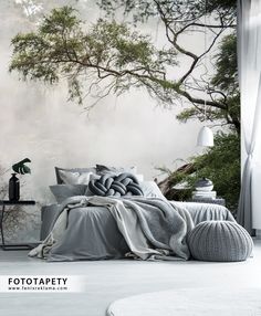 a bed sitting under a tree next to a window with fog in the air behind it