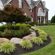 a large house with landscaping in front of it