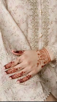 a woman's hand with henna on it