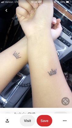 two wrist tattoos with crowns on them