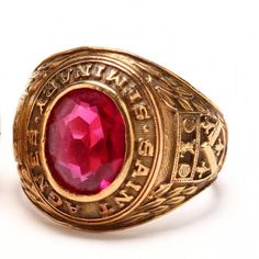 Surprise your favorite vintage lover (or treat yourself) with this gorgeous ring! This exquisite 10 karat solid yellow gold class ring is stamped 1958 St Agnes Seminary Brooklyn NY, and is bezel-set to the center with an oval-cut ruby. The ruby measures 10.9 millimeters long by 8.57 millimeters wide and weighs an estimated 4.5 carats. It is testing as ruby on our Presidium Gem Tester; however, it is likely a lab-grown synthetic. The ring is 17.12 millimeters wide at the top and tapers to 4.84 mi Vintage Gold Ruby Ring Collectible, Vintage Collectible Ruby Ring, Classic Gold Ruby Ring Collectible, Vintage Oval Ruby Ring In Gold, Vintage Engraved Ring With 17 Jewels For Anniversary, Vintage Red Signet Ring Stamped 14k, Vintage Engraved Ring Stamped 14k For Promise, Vintage Engraved Ruby Ring For Formal Occasions, Vintage Red Engraved Signet Ring