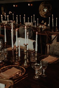 the table is set with candles and place settings