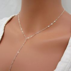 Made of solid sterling silver, the dainty lace chain makes this y-style necklace stand out. The drop portion of the chain measures approximately 5 inches long. Please leave a note at checkout if you want this length changed. Necklace closes with a spring-ring clasp and includes a 1 inch extension chain for an adjustable fit.  925 sterling silver 1 inch extender added  spring ring clasp drop chain measures 5 inches  SIZING - PLEASE READ: Note that necklaces will fit differently depending on a person's size. Please measure. The drop portion is NOT included in total necklace length because it is a separate piece of chain.  RETURNS/EXCHANGES: Necklaces under 16 inches are NOT able to be returned/exchanged. Please measure yourself to be sure you don't order too short. Sterling Silver Lariat Necklace With Long Drop, Sterling Silver Long Drop Lariat Necklace In Silver, Silver Sterling Lariat Necklace With Long Drop, Silver Lariat Necklace With Delicate Chain For Party, Silver Chain Lariat Necklace, Delicate Silver Chain Necklace, Silver Sterling Silver Long Drop Lariat Necklace, Minimalist Silver Lariat Necklace For Party, Silver Minimalist Lariat Necklace For Party