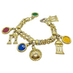 Timeless and classic charm bracelet. Designed with an 18 karat yellow gold and diamond link chain .The charms include 4 enameled peso's coin charms , along with important European and American hallmarks. The bracelet measures 7.25". Diamond weight 0.50 carats Stamped 750 Travel Charm Bracelet, American Landmarks, Flexible Bracelet, Travel Charms, Vintage Charm Bracelet, Gold Link Bracelet, Diamond Eyes, Gold Charm Bracelet, Bagan