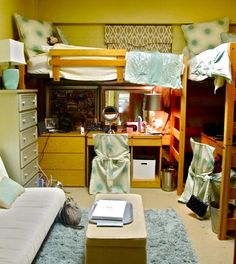 a room with bunk beds, desks and other furniture in it's center