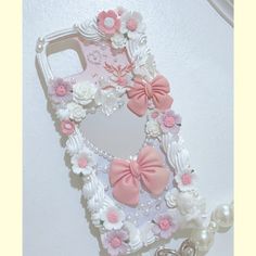 a cell phone case decorated with flowers and pearls