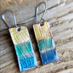 Copper Enamel earrings created with transparent enamels on textured copper. This luminous enamel gets a wonderful flash with light.  Enamel is carefully applied wet with a brush after it has been washed multiple times to create excellent clarity. Handcrafted in my studio.  Check out also chicken scratch textured version: https://bluefinnstudio.etsy.com/listing/1721866529 Stainless steel or sterling silver hook earwires. (hypoallergenic). Earrings come with silicone stoppers. Handmade in USA. WHAT IS ENAMELED COPPER? Enameling is glass fused to metal at high heat. Enamel is fused to copper using a kiln or a torch. Enamels are finely ground glass, like fine sand. They may be opaque or transparent; their colors comes from various oxides. How to care for enameled copper: Enamel is glass, not p Torch Fired Enamel Jewelry, Copper Uses, Artisan Jewelry Handmade, Multicolor Earrings, Rectangle Earrings, Enameled Copper, Enamels, Hypoallergenic Earrings, Enamel Earrings