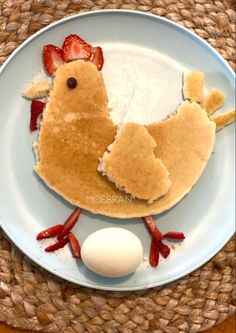 a plate that has some kind of food on it with strawberries and eggs in the middle