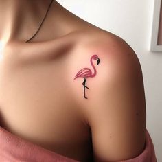 a pink flamingo tattoo on the left shoulder and right breast is shown in this image