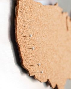 a close up of a piece of wood with nails stuck to it's surface