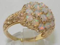 *This large flower ring is made from 585 14K (14ct 14Kt) Yellow Gold with Genuine Natural Semi-precious Australian Opals.*Total Height 7mm, Width 15mm, Length 16mmLike all my jewelry pieces, this ring is made in my own workshop. PLEASE MAKE SURE YOU STATE THE FINGER SIZE YOU REQUIRE WITH YOUR PAYMENT AND ALSO INCLUDE YOUR TELEPHONE NUMBER FOR DELIVERY COURIER.This magnificent piece is set with nineteen fiery Opals all measuring 2.8mm in a delightful chunky cluster setting. The carving on the sho Engagement Ring Victorian, Flower Anniversary, Opal Engagement Ring, Opal Engagement, Engagement Rings Opal, Australian Opal, Natural Opal, Flower Ring, Victorian Style