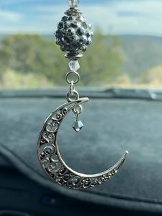 a car dashboard with a silver charm hanging from it's side