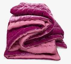 a pile of purple blankets folded on top of each other