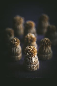 several small knitted hats sitting next to each other