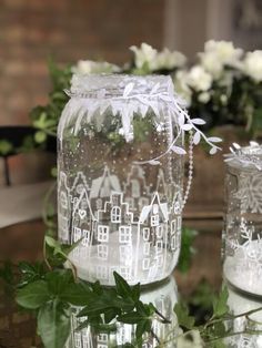 two clear glass vases sitting on top of a table