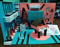 a paper model of a piano and musical instruments