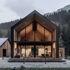 a modern house in the middle of a forest with mountains in the backgroud