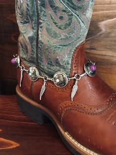 Beautiful hand crafted boot jewelry. These are faux silver concho with indian head and plum colored floral stone conchos. Faux  silver feathers dangle in between the  Conchos. This boot bracelet  has Lobster clasp.   This is a Unique style not to be found anywhere but Old hands Creations! This one is 14.5" in total length. Style In #1. Check out our chain bracelets and save 20% when you buy 2 items. Please check out our other items as some are complimentary to this item. If you buy 2 or more ite Western Concho Bracelets For Festival, Western Style Concho Bracelets For Festivals, Handmade Western Jewelry For Festival, Handmade Western Style Jewelry For Festival, Western Style Handmade Festival Jewelry, Motorcycle Boot, Boot Chains, Boot Bracelet, Boot Bling