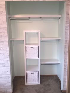 an empty walk in closet with shelves and baskets