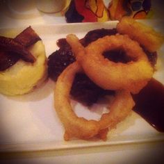 some onion rings are sitting on a plate