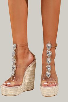 Indulge in the ultimate luxury with these Women's High Heel Sandals adorned with sparkling rhinestone chains. Featuring a jute sole and transparent heel, these sandals exude a bold and fashionable vibe. Perfect for any vacation, these sandals have an open toe design, a simple yet elegant pattern, and an ankle strap for added support. The wedge heels measure an ultra high 15cm/5.9 inches, while the upper and lining materials are made of premium PVC. Step out in style and comfort with these exclus Summer Crystal High Heels, Crystal Open Toe Heels For Summer, Summer Crystal Heels With Rhinestones, Crystal Embellished Heels For Summer, Glamorous Clear Sandals For Summer, Summer Rhinestone Heels, Clear Wedge Sandals For Spring Party, Glamorous Clear Sandals With Rhinestones, Clear Platform Sandals For The Beach