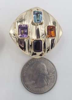 Title: Multicolor Gemstones Round Corner Square 14KT Yellow Gold Omega Clip Earrings Designer: Unbranded Material14KT Stamped Style: Vintage Gemstone Details All measurements are approximate and may vary slightly from the listed dimensions.1ar Approximately 5mm x 4mm each 1Amethyst Rectangular 1 Blue Topaz Rectangular 1 Orange Citrine Rectangular 1 Garnet Rectangular Estimated Measurements of the item30.23mm x 20.23mm x 5.83mm Estimated Total Weight of the Item DWT: 7.6 Grams: 11.7 Condition: Pr Gold Multi-stone Gemstones In Fine Jewelry Style, Gold Multi-stone Fine Jewelry Gemstones, Luxury Multicolor Earrings With Gemstone Accents, Luxury Gold Multi-stone Gemstones, Multicolor Gemstone Accented Earrings For Formal Occasions, Luxury Gold Earrings With Stones, Gold Oval Multi-stone Earrings, Oval Gold Multi-stone Earrings, Designer Multi-stone Gold Jewelry