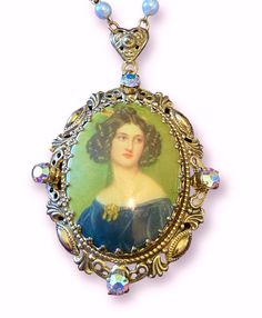 "Beautiful vintage west German brass filigree necklace.  Painted limoge portrait cameo set with a fancy gallery bezel.  Surrounded by aurora borealis crystal rhinestones.  chain 25\" cameo 2.5\" x 1.75\" Visit www.TheFjeldGallery.com for expanded inventory and all items at discounted prices!" Victorian Cabochon Jewelry For Collectors, Victorian Cabochon Collectible Jewelry, Art Nouveau Cameo Jewelry Gift, Victorian Baroque Collectible Jewelry, Victorian Necklace With Large Pendant Collectible, Victorian Necklace With Large Pendant For Collectors, Ornate Cameo Necklace Collectible, Ornate Cameo Necklace For Collectors, Aurora Borealis Crystal