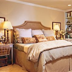 a large bed in a bedroom next to two lamps