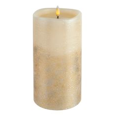 a candle that is sitting in front of a white background with gold flecks