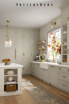 the kitchen is clean and ready to be used for cooking or baking, with white cabinets and gold trim