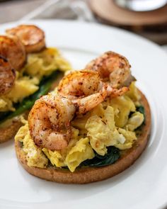 two pieces of bread with shrimp and eggs on it