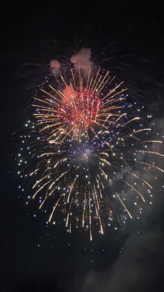 fireworks are lit up in the night sky with bright colors and sparkles on them