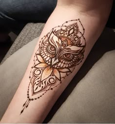 an owl tattoo on the arm and leg is shown in black ink with gold accents